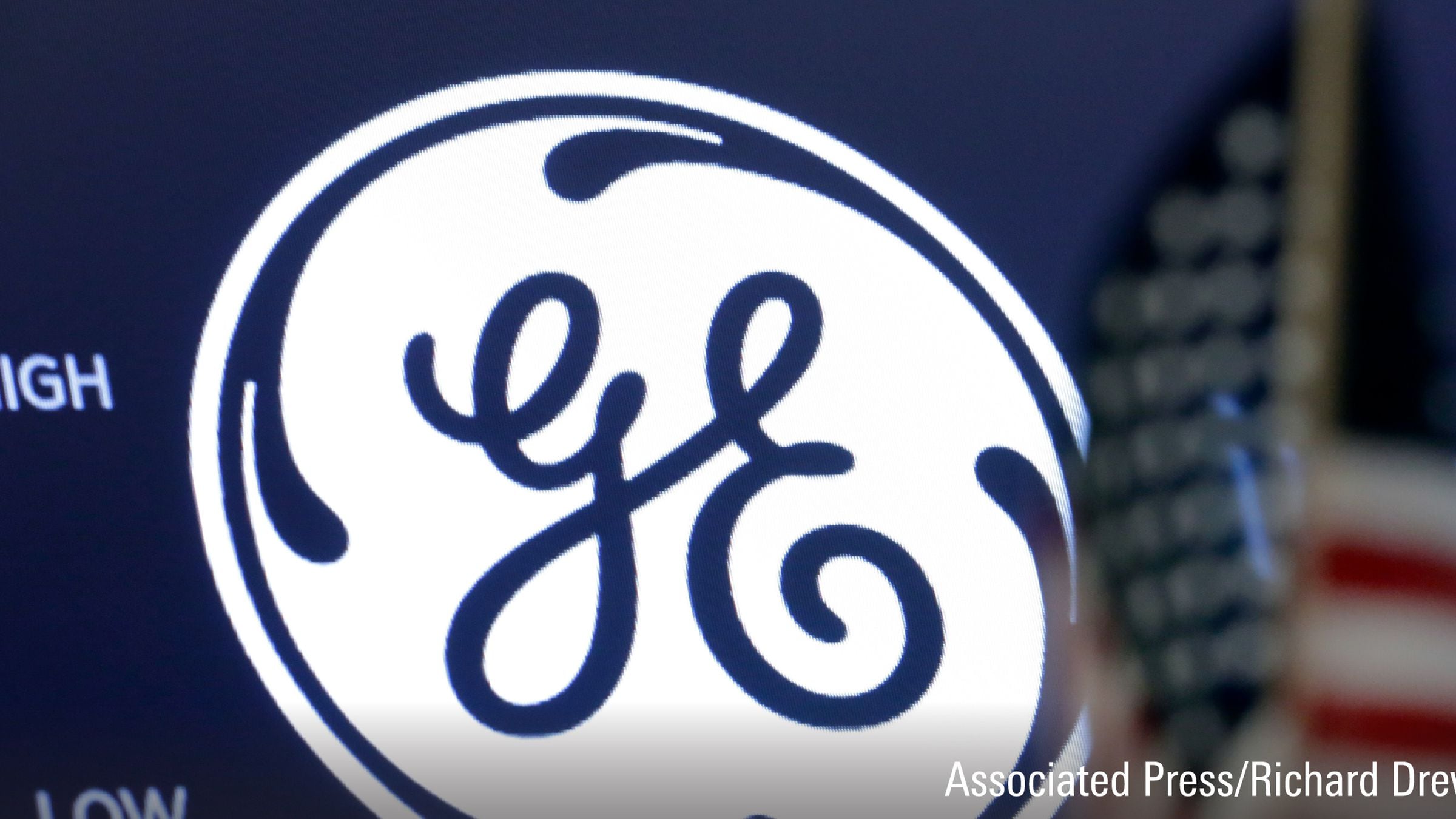 The General Electric logo appears above a trading post on the floor of the New York Stock Exchange.