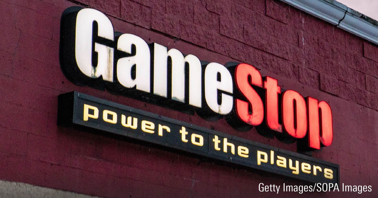 Gamestop logo signage superimposed on a red-brick building